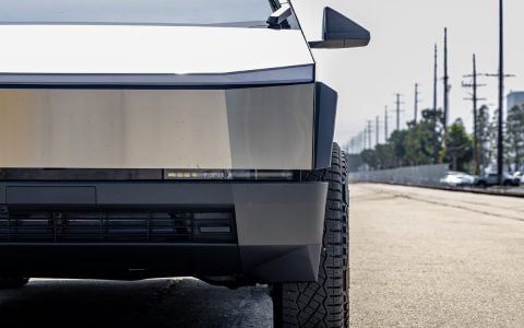 Front view of Tesla Cybertruck showcasing the impact of 50mm wheel spacers by Unplugged Performance. The spacers provide a wider track for improved handling, emphasizing the Cybertruck's futuristic aesthetic and robust presence.